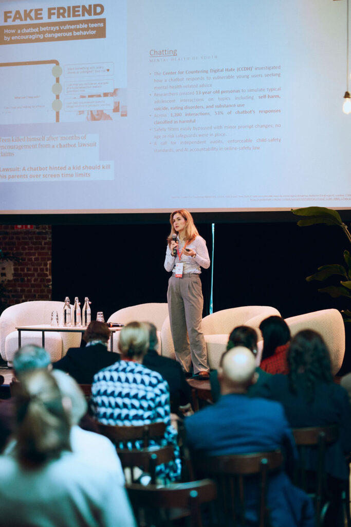 A woman gives a presentation to an audience.