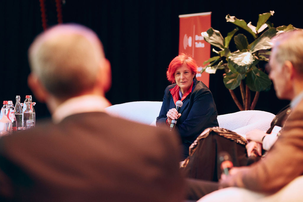 woman is holding a microphone