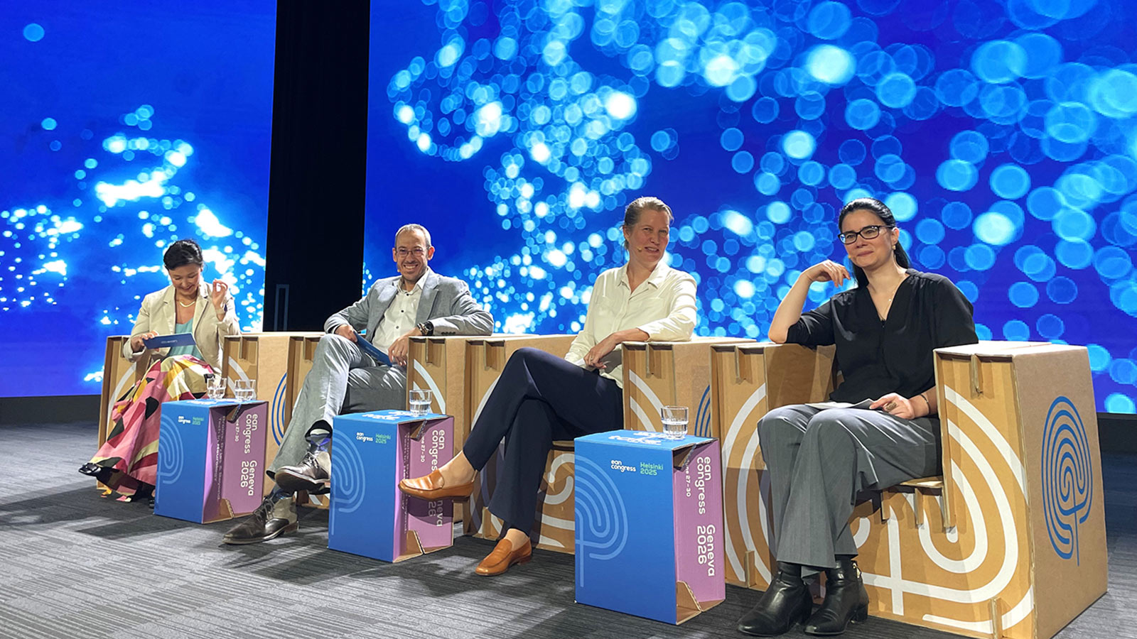 people sitting in chairs on a stage